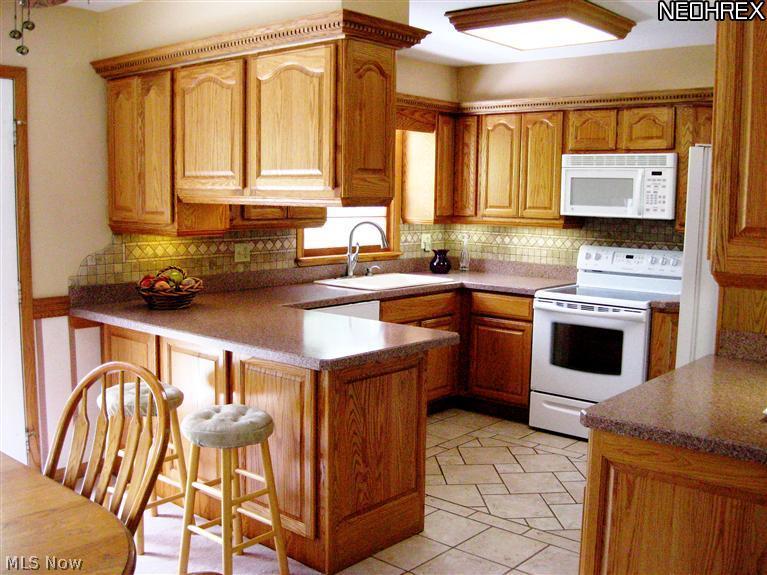 3110 Dutt Road Barberton, OH 44203 - Photo 5 of 21 Oak Kitchen with Tile Flooring and opens to dining area.
