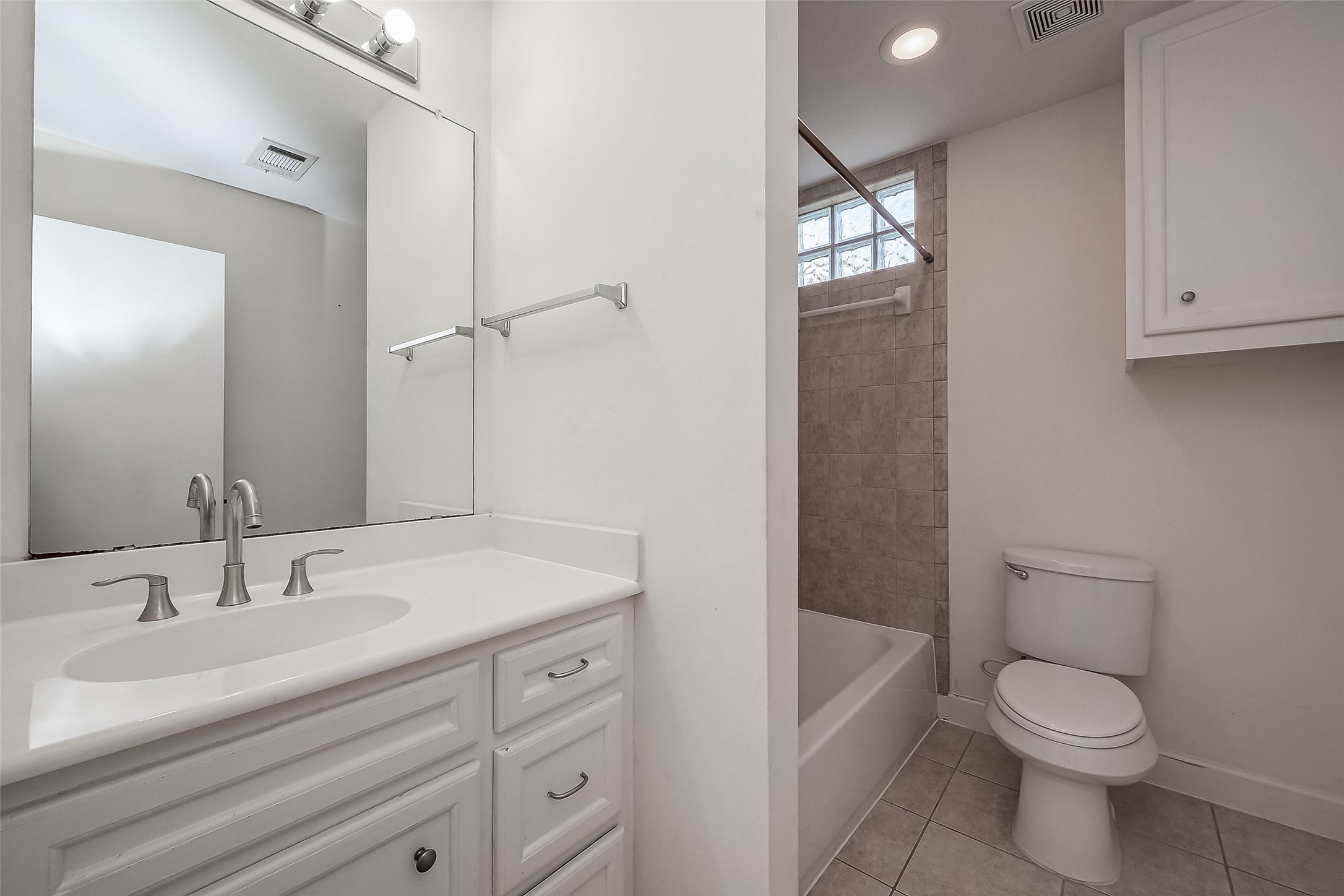 2710 Hullsmith Drive, Unit 1503 Houston, TX 77063 - Photo 9 of 14 a bathroom with a sink a toilet and shower