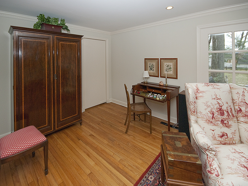 159 Oenoke Ridge New Canaan, CT 06840 - Photo 11 of 28 a bedroom with a bed and wooden floor