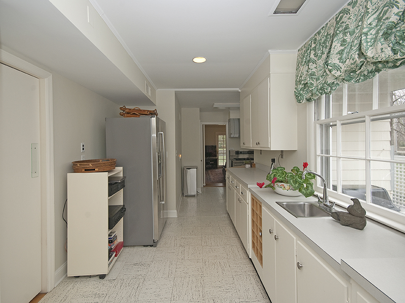 159 Oenoke Ridge New Canaan, CT 06840 - Photo 15 of 28 a kitchen with a sink and refrigerator