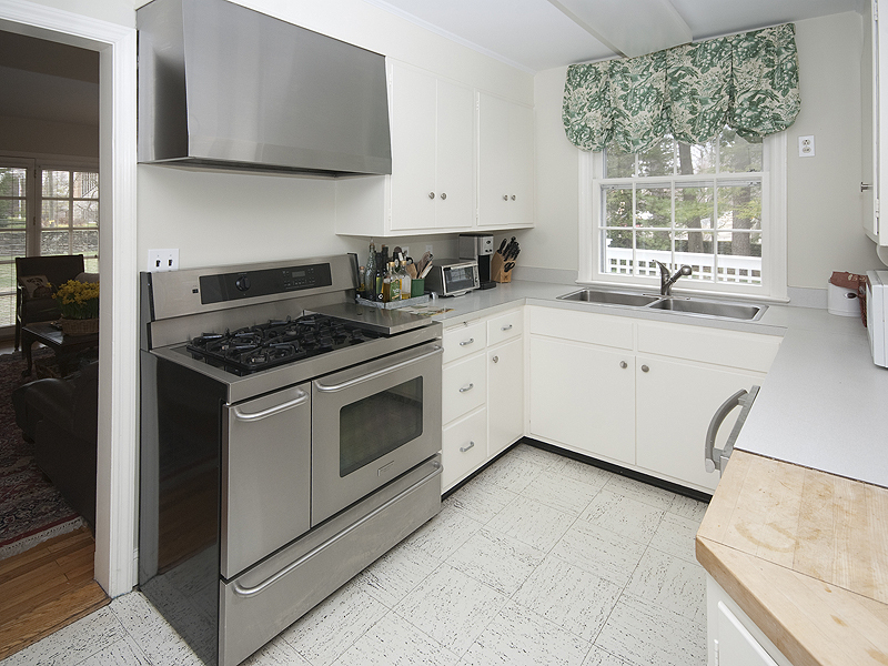 159 Oenoke Ridge New Canaan, CT 06840 - Photo 16 of 28 a kitchen with a stove a sink and a window
