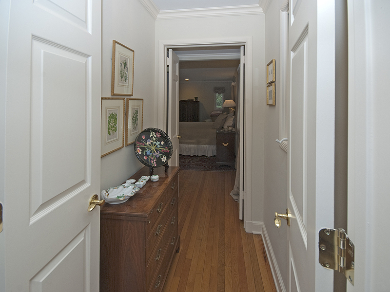 159 Oenoke Ridge New Canaan, CT 06840 - Photo 18 of 28 a hallway with a view of bedroom with wooden floor