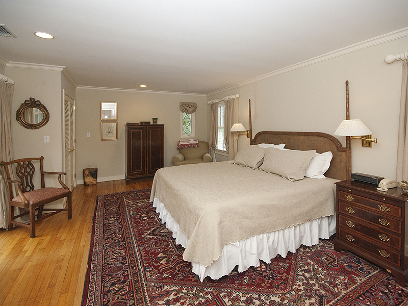 159 Oenoke Ridge New Canaan, CT 06840 - Photo 19 of 28 a bedroom with a bed and a lamp on dresser
