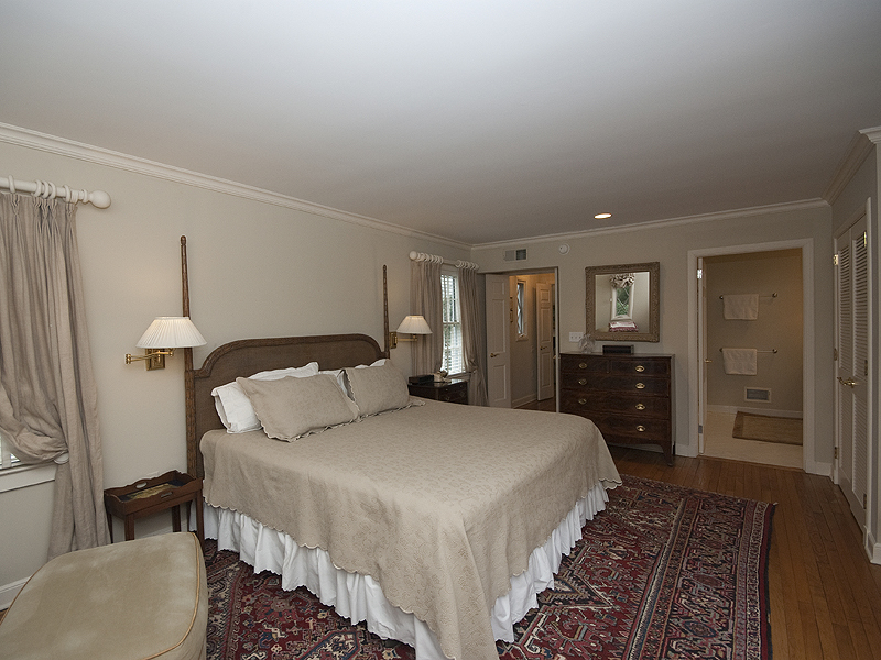159 Oenoke Ridge New Canaan, CT 06840 - Photo 20 of 28 a large bedroom with a bed and wooden floor