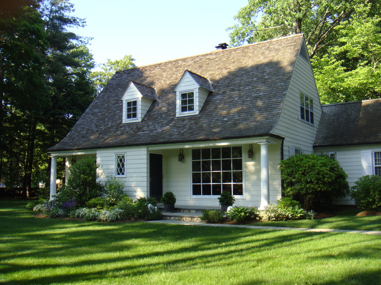 159 Oenoke Ridge New Canaan, CT 06840 - Photo 2 of 28 a front view of a house with a yard