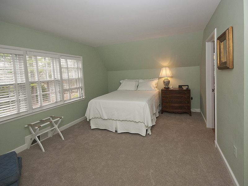 159 Oenoke Ridge New Canaan, CT 06840 - Photo 22 of 28 a bedroom with a bed chair and a window