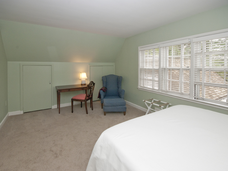 159 Oenoke Ridge New Canaan, CT 06840 - Photo 23 of 28 a spacious bedroom with a bed and a window