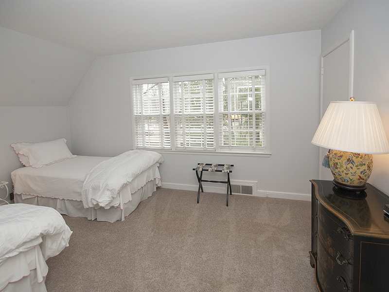 159 Oenoke Ridge New Canaan, CT 06840 - Photo 25 of 28 a bedroom with a bed and a table in it