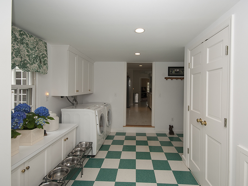 159 Oenoke Ridge New Canaan, CT 06840 - Photo 28 of 28 a kitchen with a checkered floor and white cabinets