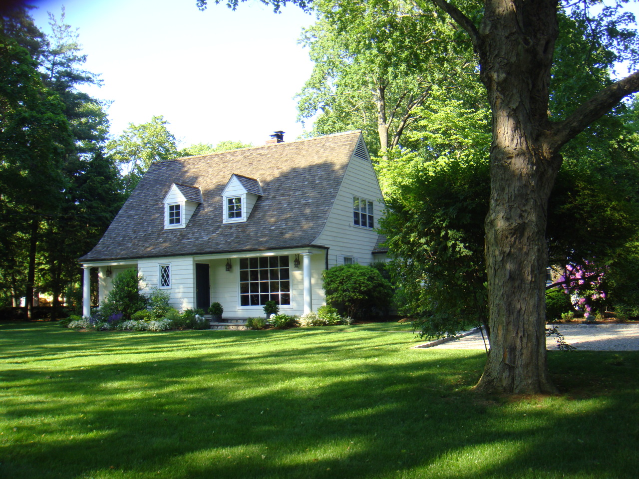 159 Oenoke Ridge New Canaan, CT 06840 - Photo 3 of 28 a front view of a house with a garden