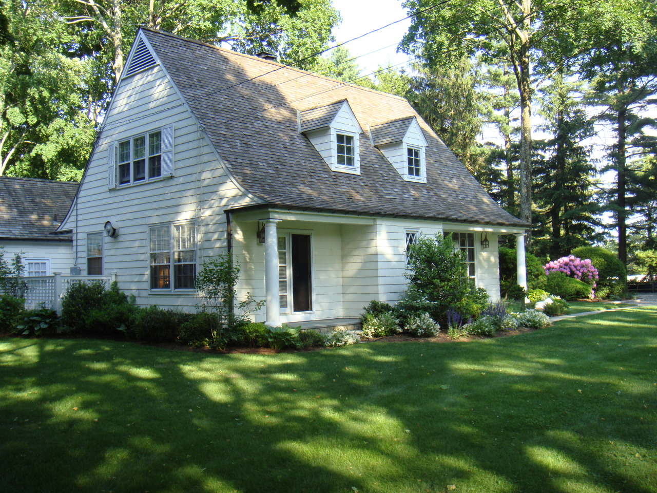 159 Oenoke Ridge New Canaan, CT 06840 - Photo 4 of 28 a front view of a house with a yard and garage