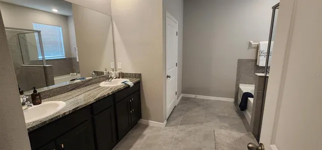 a bathroom with a double vanity sink and a mirror