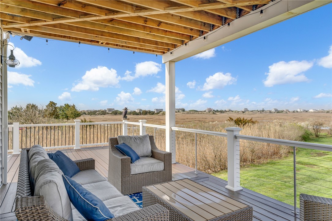 32 Breach Drive Westerly, RI 02891 - Photo 26 of 43 A covered deck connects to the wrap around deck and provides a great spot for enjoying sunsets.