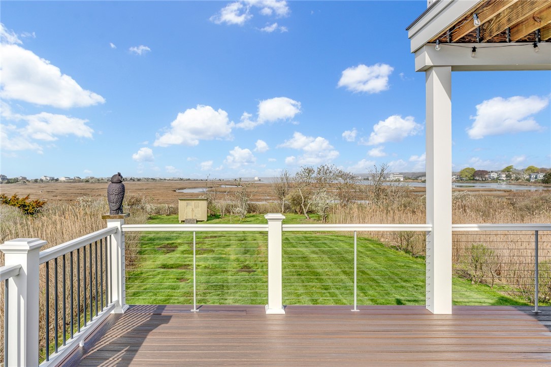 32 Breach Drive Westerly, RI 02891 - Photo 28 of 43 The wrap around deck shows a lush lawn and the salt pond beyond.