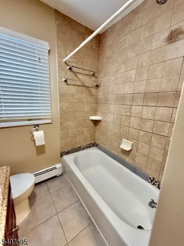 a bathroom with a tub and toilet