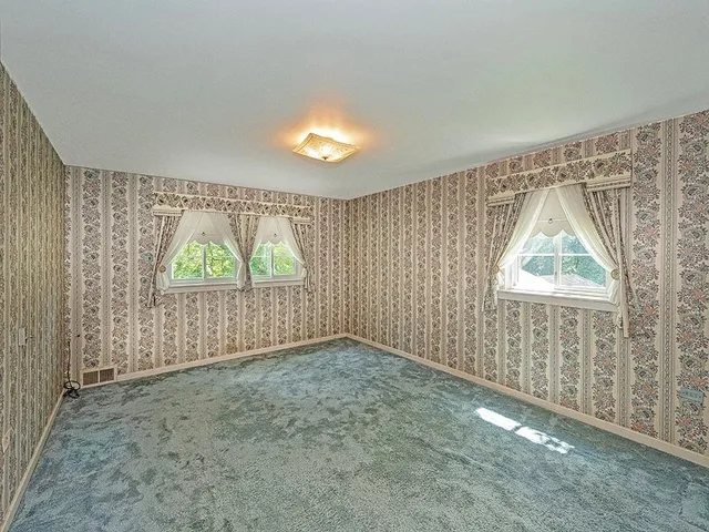 a view of a hallway with wooden shelves