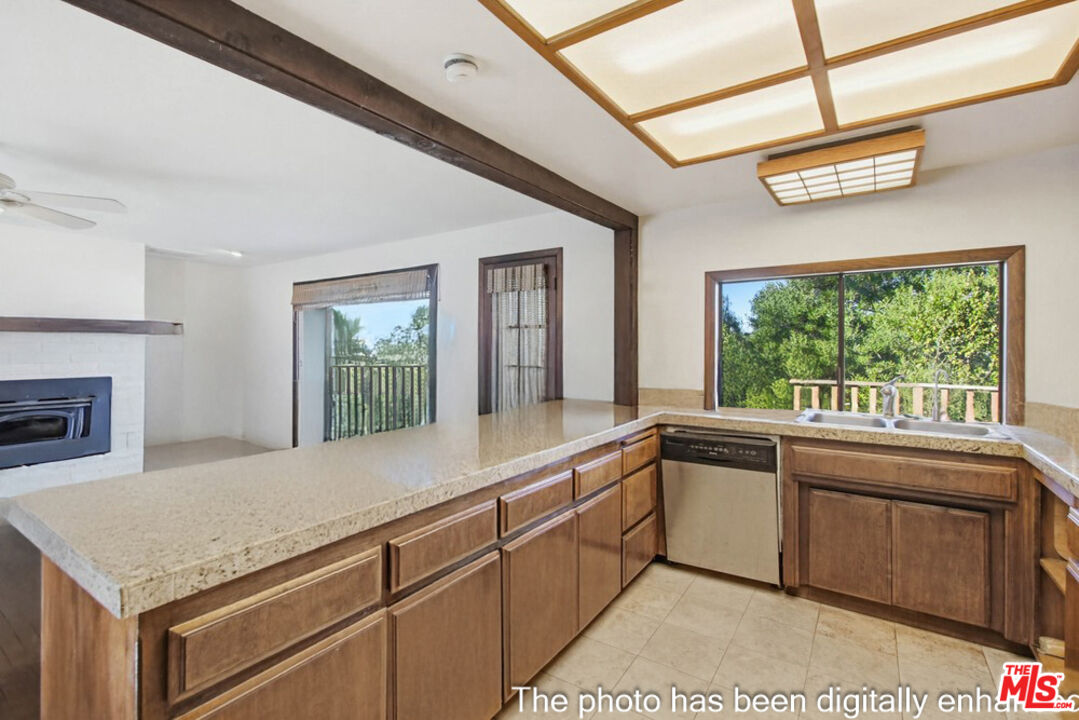 3709 Buena Creek Road Vista, CA 92084 - Photo 11 of 62 a kitchen with stainless steel appliances granite countertop a stove a sink and a microwave