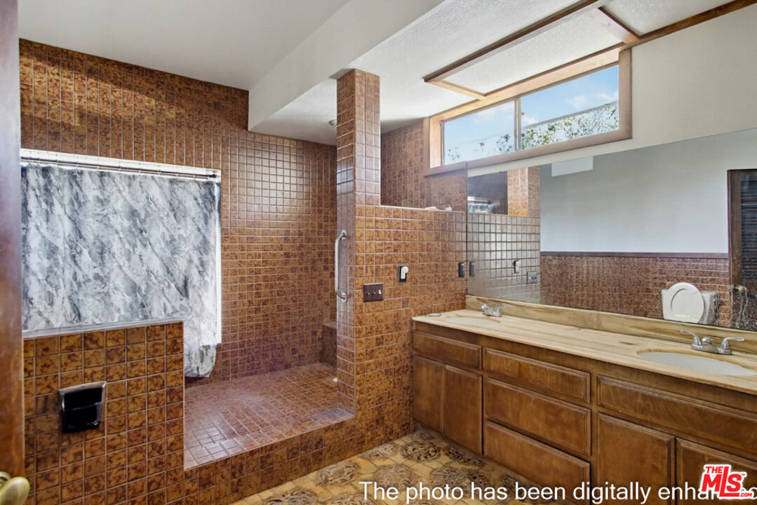 3709 Buena Creek Road Vista, CA 92084 - Photo 18 of 62 a bathroom with a sink a toilet and shower