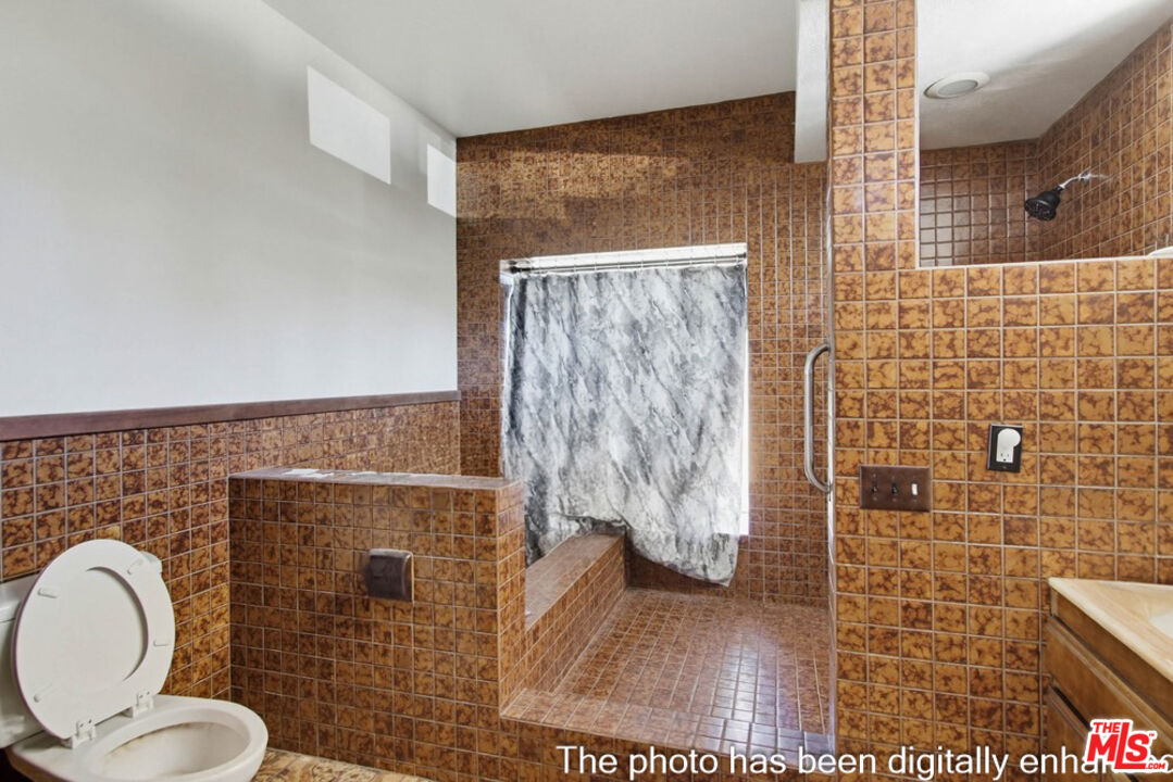 3709 Buena Creek Road Vista, CA 92084 - Photo 19 of 62 a bathroom with a toilet and a shower