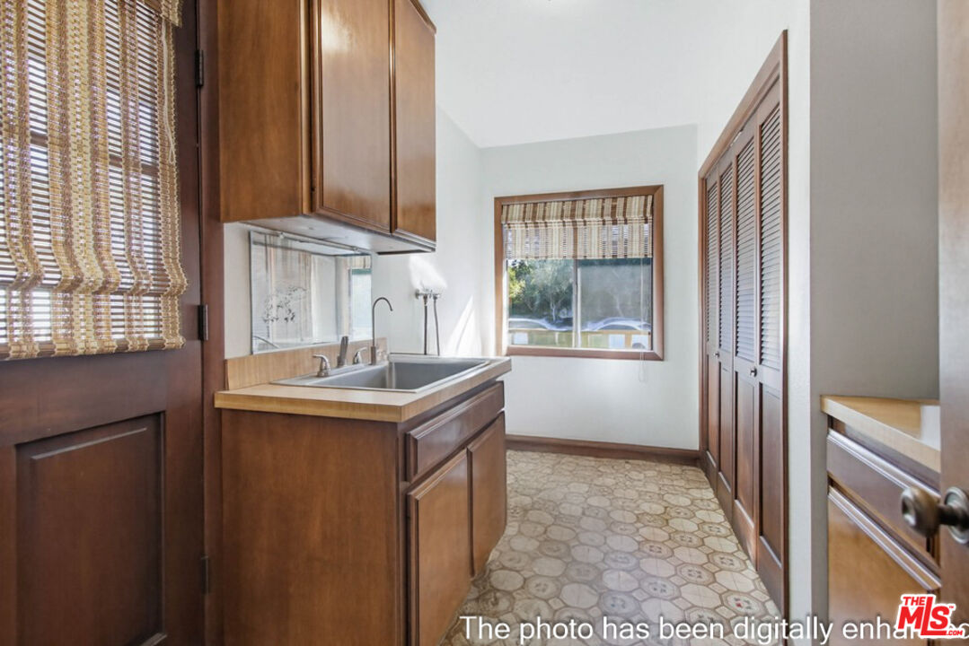 3709 Buena Creek Road Vista, CA 92084 - Photo 28 of 62 a kitchen with kitchen island a sink a stove and a window