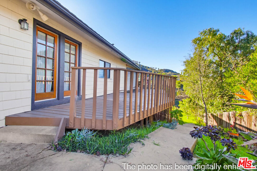 3709 Buena Creek Road Vista, CA 92084 - Photo 40 of 62 a view of wooden house with a large window and flower plants