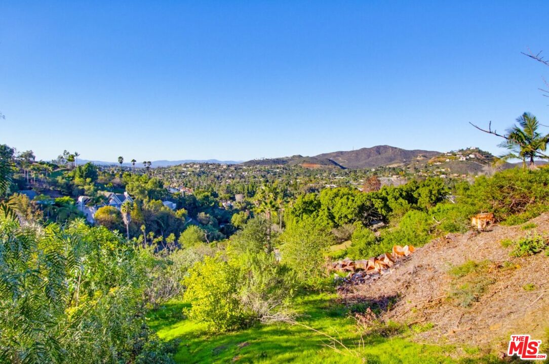 3709 Buena Creek Road Vista, CA 92084 - Photo 45 of 62 a view of a lush green field with mountains in the background