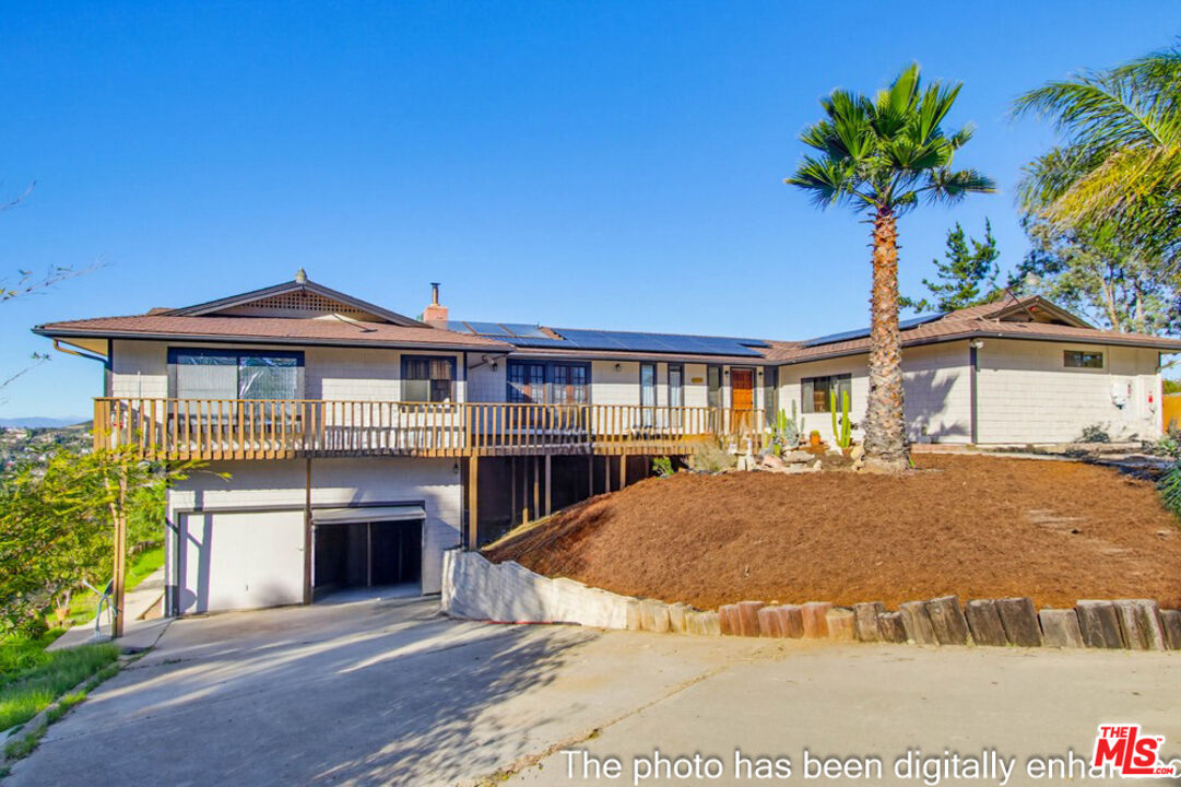 3709 Buena Creek Road Vista, CA 92084 - Photo 49 of 62 a front view of a house with a yard and garage