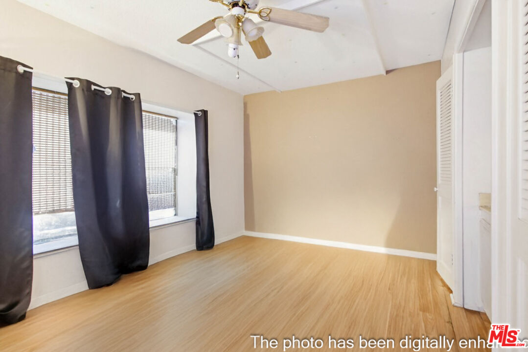 3709 Buena Creek Road Vista, CA 92084 - Photo 52 of 62 a view of an empty room with wooden floor and a window