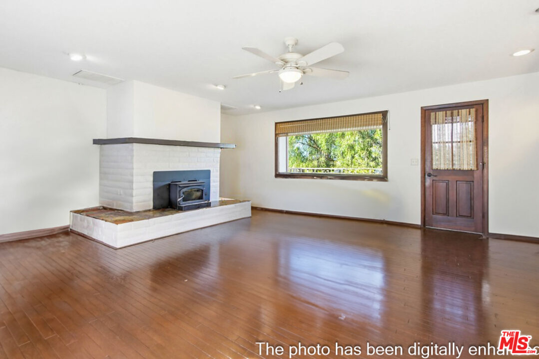 3709 Buena Creek Road Vista, CA 92084 - Photo 7 of 62 an empty room with windows fireplace and wooden floor