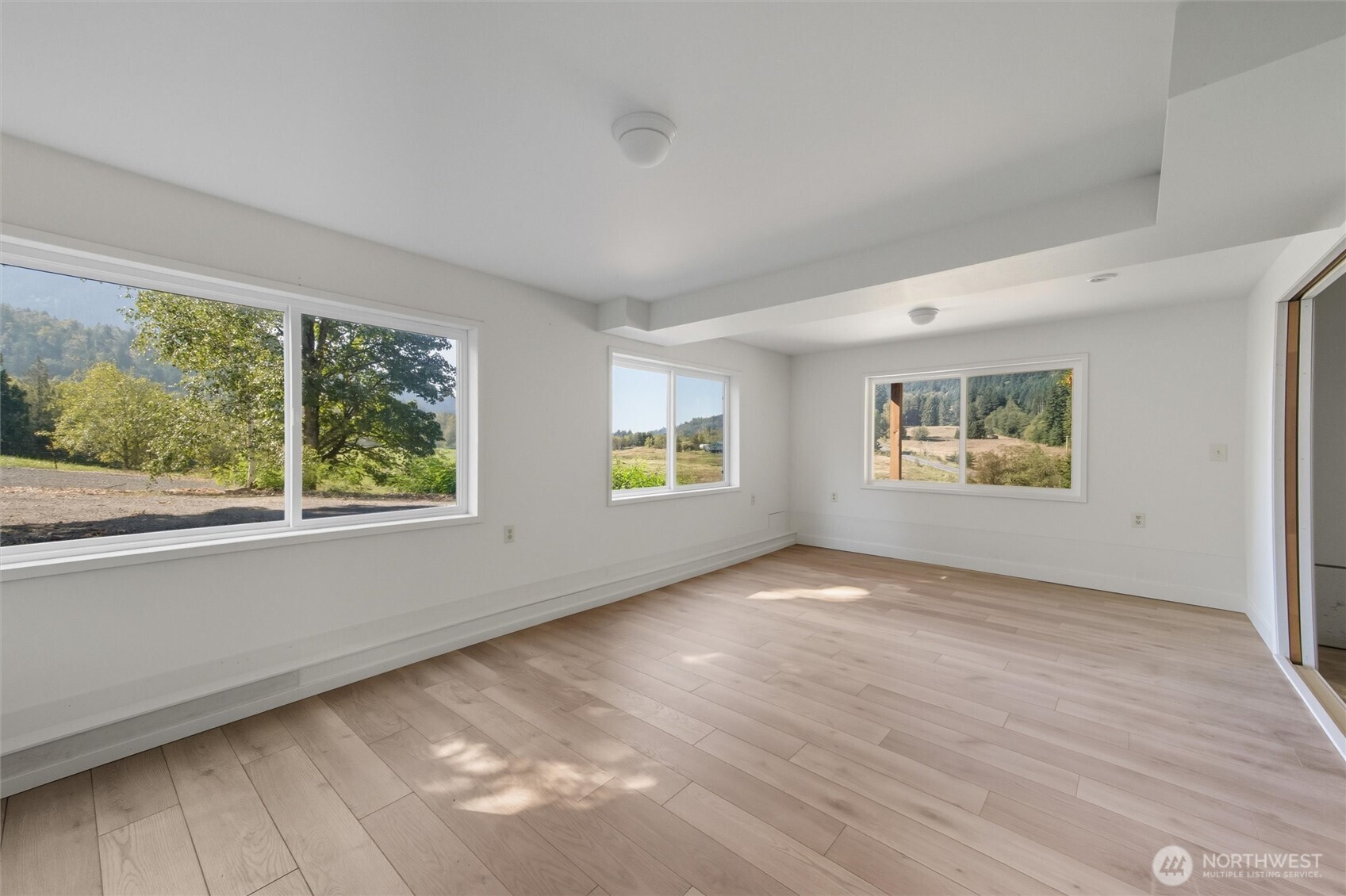 4955 South Pass Road Sumas, WA 98295 - Photo 24 of 40 a view of an empty room with a window and wooden floor