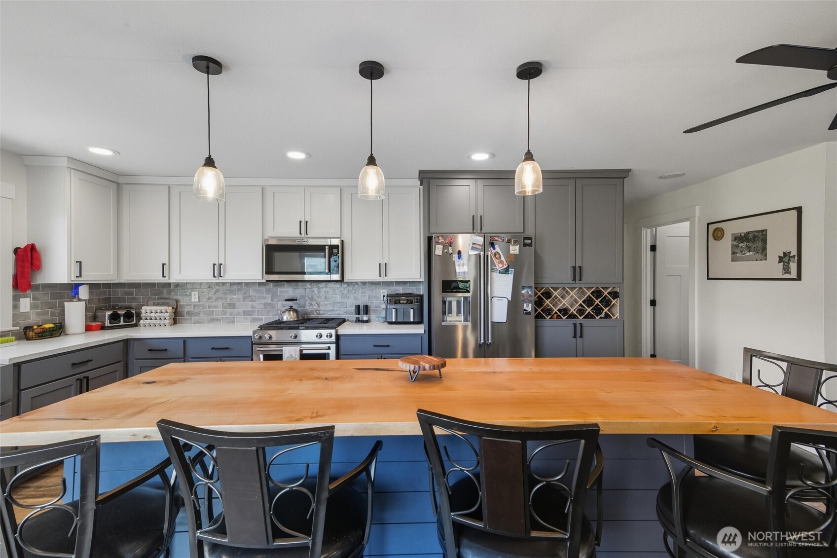 4955 South Pass Road Sumas, WA 98295 - Photo 4 of 40 a kitchen with stainless steel appliances granite countertop a dining table chairs and white cabinets