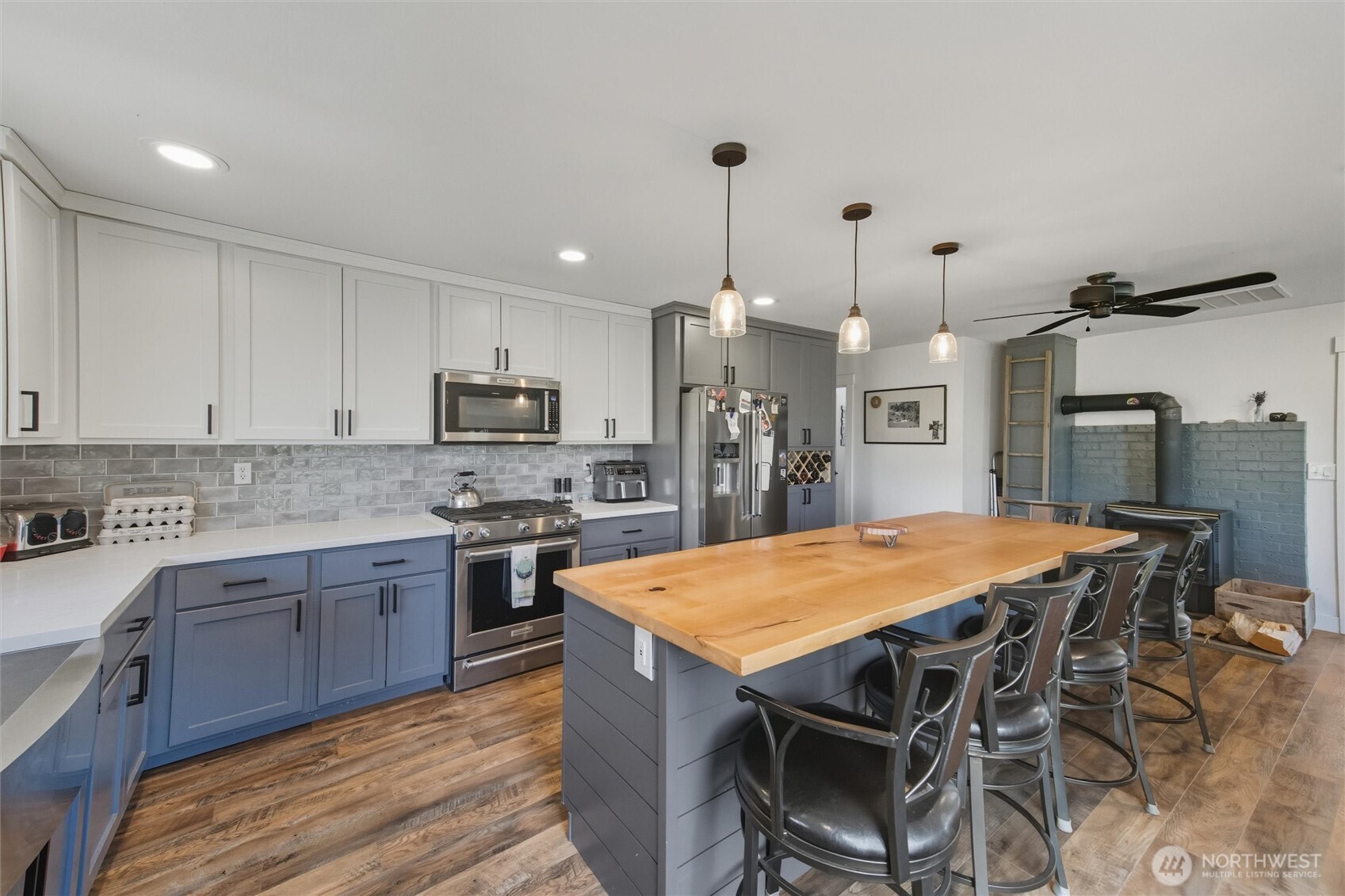 4955 South Pass Road Sumas, WA 98295 - Photo 5 of 40 a kitchen with stainless steel appliances kitchen island granite countertop a table chairs sink and cabinets