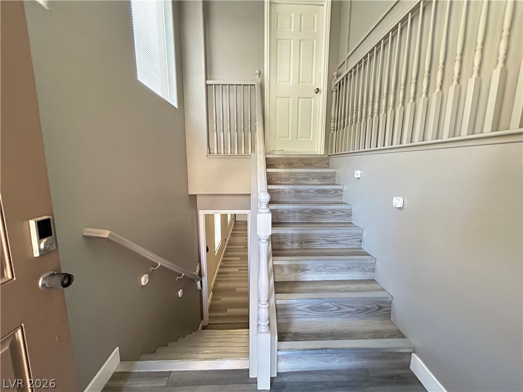 6538 Elm Spring Las Vegas, NV 89148 - Photo 2 of 29 Artfully crafted staircase with durable flooring leads to upper and lower levels.