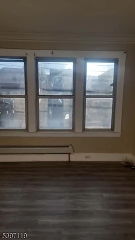 a view of wooden floor and windows in a room