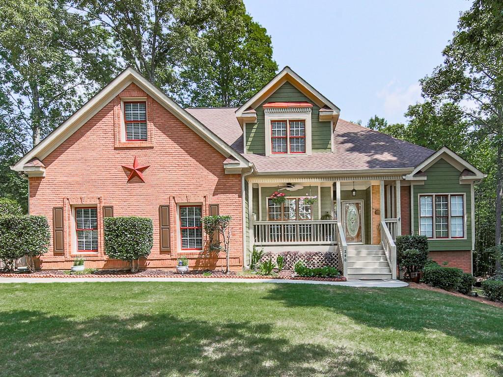 240 Carmel Ridge Road Canton, GA 30114 - Photo 1 of 1 a front view of a house with a yard
