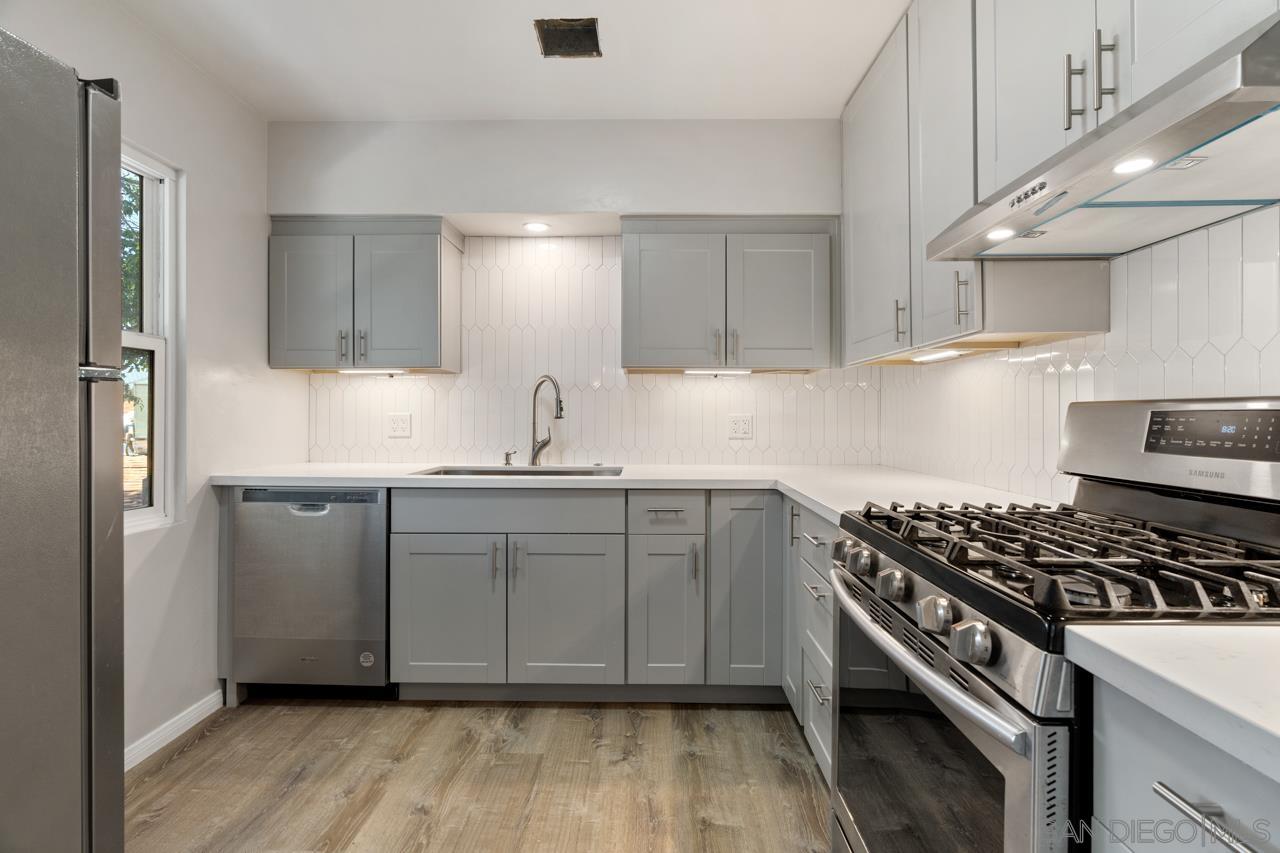 a kitchen with kitchen island white cabinets and stainless steel appliances