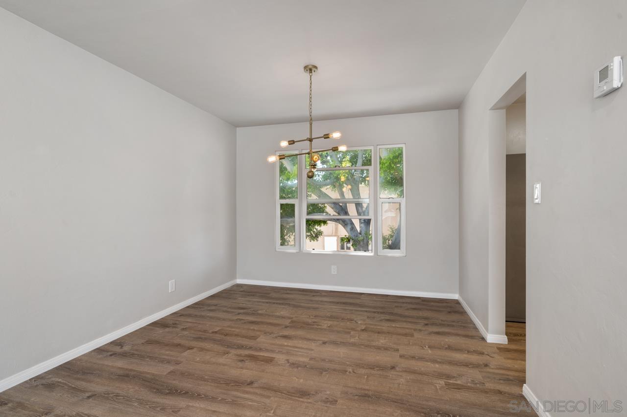 3276 Main Street Lemon Grove, CA 91945 - Photo 16 of 75 an empty room with wooden floor chandelier and window