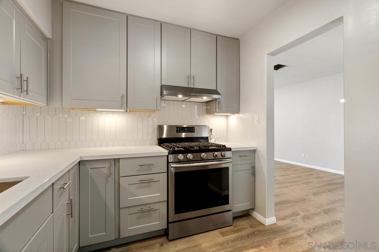 3276 Main Street Lemon Grove, CA 91945 - Photo 4 of 75 a kitchen with white cabinets and stainless steel appliances
