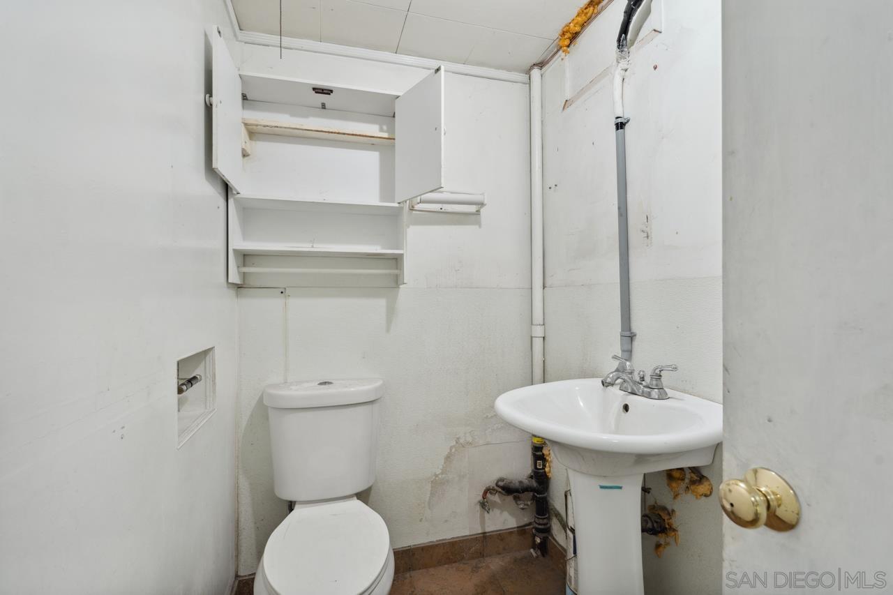 3276 Main Street Lemon Grove, CA 91945 - Photo 75 of 75 a bathroom with a toilet sink and mirror