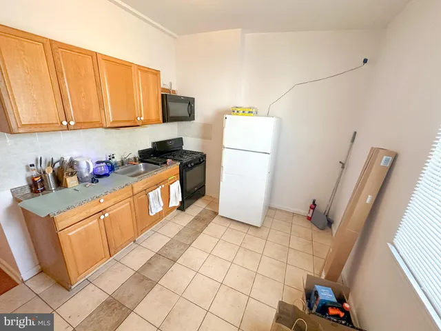 a kitchen with a sink a refrigerator and a stove