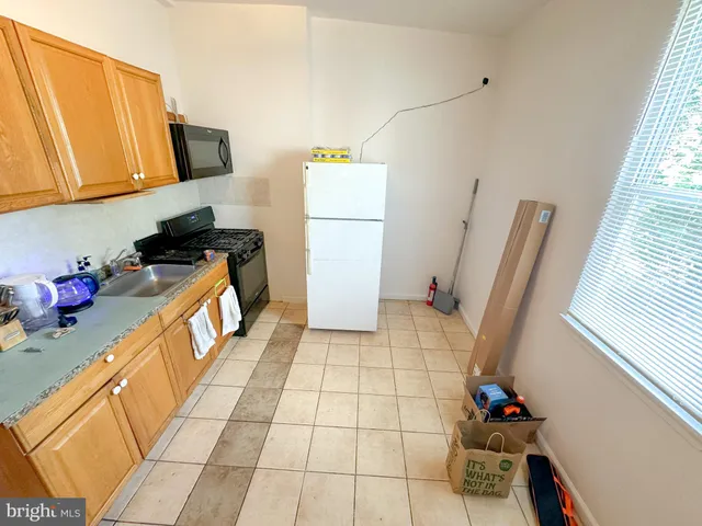 a kitchen with a sink and a refrigerator
