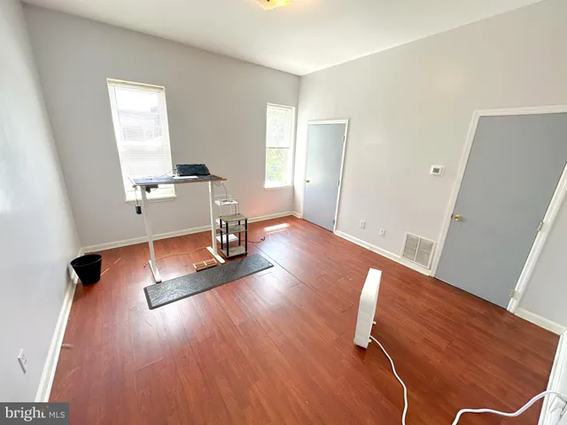 a view of a room with wooden floor