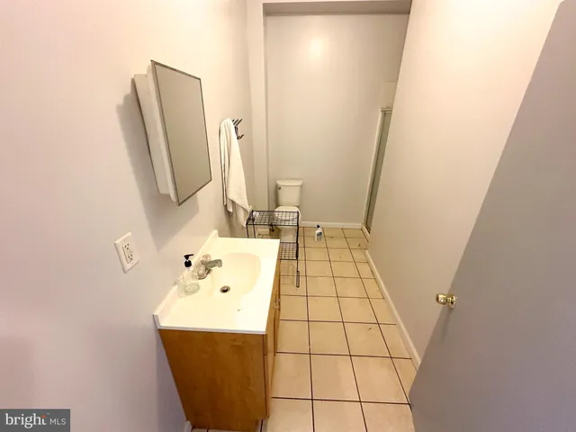 a white toilet sitting next to a shower