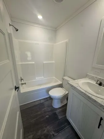 a view of a room with wooden floor and brick walls