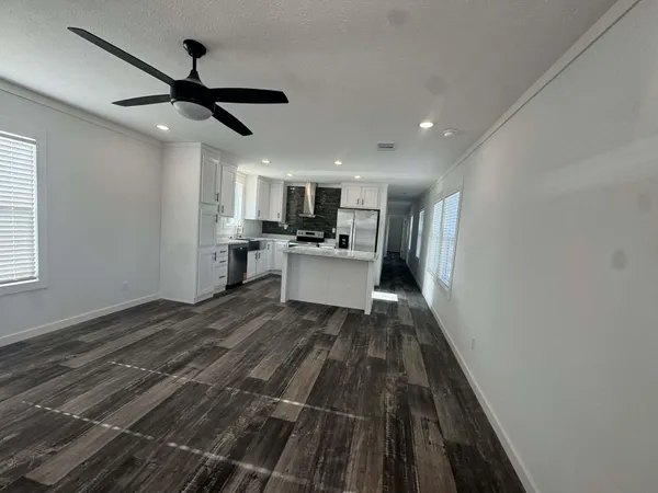 a kitchen with a refrigerator and a sink