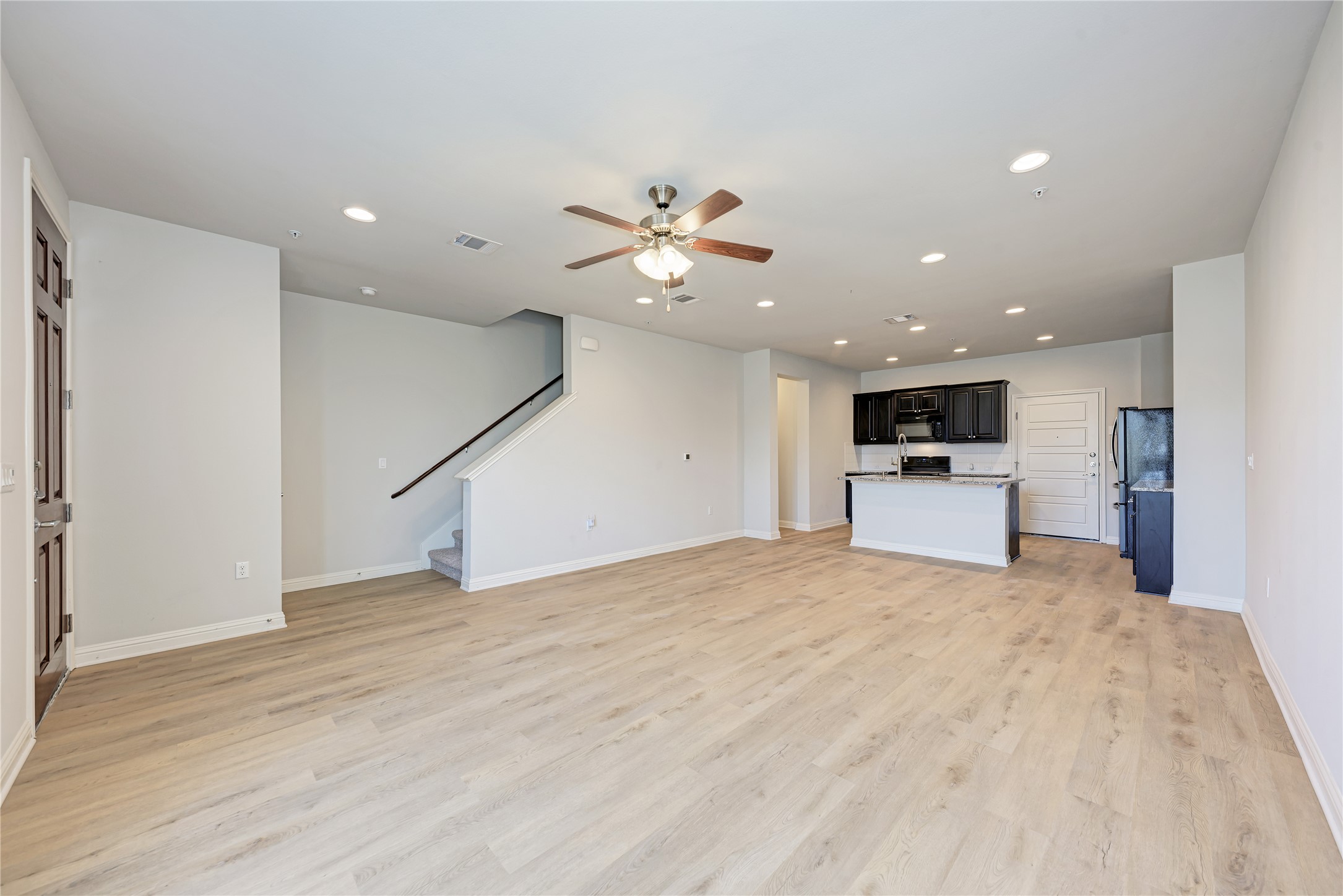 6814 East Riverside Drive, Unit 32 Austin, TX 78741 - Photo 2 of 26 a view of kitchen with a sink a kitchen refrigerator and a microwave