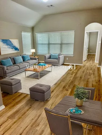 a living room with furniture and a table