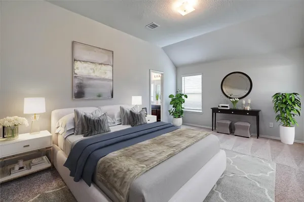 a bedroom with a bed mirror and a potted plant