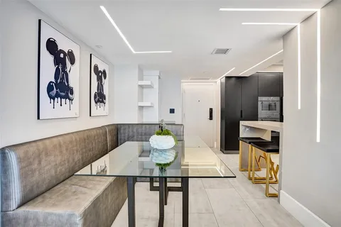 a living room with furniture a large window and table