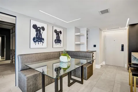 a living room with furniture a rug and a floor to ceiling window